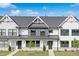 Charming townhomes with modern farmhouse appeal, featuring white siding and a well-manicured lawn at 913 Myers Point Dr, Morrisville, NC 27560