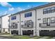 Townhome exteriors featuring white siding, black trim, balconies, and dark garage doors at 913 Myers Point Dr, Morrisville, NC 27560