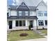 Charming new construction townhome featuring a modern white facade and manicured lawn at 913 Myers Point Dr, Morrisville, NC 27560
