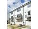 Modern townhomes showcasing white siding, balconies, and individual garages at 913 Myers Point Dr, Morrisville, NC 27560