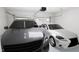 A well-lit, two-car garage featuring a modern SUV and a sleek sedan parked neatly inside at 913 Myers Point Dr, Morrisville, NC 27560