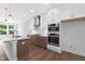Modern kitchen featuring white cabinets, stainless appliances, and a functional island at 913 Myers Point Dr, Morrisville, NC 27560