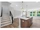 Modern kitchen with island, stainless steel appliances, and open access to living areas at 913 Myers Point Dr, Morrisville, NC 27560