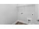 This laundry room features a washing machine hookup and white walls at 913 Myers Point Dr, Morrisville, NC 27560