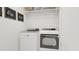 A clean laundry room equipped with modern washer and dryer units, plus shelving for storage at 913 Myers Point Dr, Morrisville, NC 27560