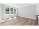 Bright living room features large windows, hardwood floors, and open space, offering versatility at 913 Myers Point Dr, Morrisville, NC 27560
