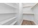 This large walk-in closet features wood flooring and shelving at 913 Myers Point Dr, Morrisville, NC 27560
