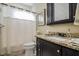 Bathroom with black cabinets, granite countertops, toilet, and a shower with a white curtain at 103 Bella Sq Sq, Smithfield, NC 27577