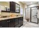 Bathroom featuring double sinks, granite counters, dark cabinets, and a glass shower at 103 Bella Sq Sq, Smithfield, NC 27577