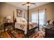 Cozy bedroom features a four-poster bed and a vibrant area rug at 103 Bella Sq Sq, Smithfield, NC 27577