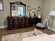 Bedroom features a wooden dresser, vanity, light gray chair, and area rug at 103 Bella Sq Sq, Smithfield, NC 27577