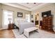 Cozy main bedroom with natural light, tray ceiling, TV, rug and ensuite bathroom access at 103 Bella Sq Sq, Smithfield, NC 27577