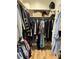 Walk-in closet with hanging clothes, built in shelves, and hardwood floors at 103 Bella Sq Sq, Smithfield, NC 27577