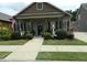 Quaint one-story home featuring a cozy front porch and manicured landscaping, creating inviting curb appeal at 103 Bella Sq Sq, Smithfield, NC 27577