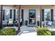 Welcoming front porch with seating, decorative plants, and a stylish glass door, perfect for relaxing outdoors at 103 Bella Sq Sq, Smithfield, NC 27577