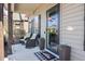 Charming covered front porch with rocking chairs, planters, and a stylish glass front door at 103 Bella Sq Sq, Smithfield, NC 27577