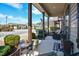 Cozy covered porch with seating, garden decor, and a view of the neighborhood street at 103 Bella Sq Sq, Smithfield, NC 27577