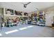 Spacious garage with ample storage space featuring shelving, overhead storage and natural light at 103 Bella Sq Sq, Smithfield, NC 27577