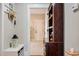 Hallway features an ornate cabinet, and a view of a white door and a neutral color scheme at 103 Bella Sq Sq, Smithfield, NC 27577