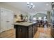 Kitchen with granite island and seating that flows into the dining room and shows an open concept at 103 Bella Sq Sq, Smithfield, NC 27577