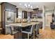 Spacious kitchen with stainless steel appliances, granite countertops, dark cabinets, island seating and light-colored flooring at 103 Bella Sq Sq, Smithfield, NC 27577