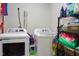 A functional laundry room with modern washer and dryer units with shelving at 103 Bella Sq Sq, Smithfield, NC 27577