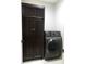 Convenient laundry room featuring a front-load washer and dryer and ample cabinet space at 103 Bella Sq Sq, Smithfield, NC 27577