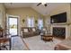 Inviting living room with a cozy fireplace, comfortable seating, and ample natural light at 103 Bella Sq Sq, Smithfield, NC 27577