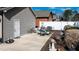 A patio with patio furniture, barbecue and yard decor, with a white fence in the background at 103 Bella Sq Sq, Smithfield, NC 27577