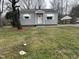 Charming one-story home with light gray siding, awning-covered windows and a simple, inviting front entrance at 104 N Garden Ave, Siler City, NC 27344