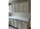 Classic white kitchen cabinets with modern gray hardware and bright white countertops at 104 N Garden Ave, Siler City, NC 27344