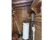 Utility room with water heater and wooden walls and ceiling at 104 N Garden Ave, Siler City, NC 27344