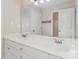 Bathroom with a double vanity sink and a large mirror. The floor and walls are light colored at 104 Wexwood Ct, Cary, NC 27519