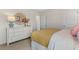 Bright bedroom with a large white dresser and a round mirror next to a queen-size bed at 124 Ethel Ln, Angier, NC 27501