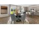Open concept dining area featuring a dark wood table, grey upholstered chairs, and luxury vinyl plank flooring at 124 Ethel Ln, Angier, NC 27501