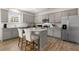 Bright kitchen featuring stainless steel appliances, granite countertops, grey cabinets, and a center island with seating at 124 Ethel Ln, Angier, NC 27501