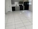 Large room, could be Gathering room or open-concept kitchen with gray cabinets and black appliances at 130 S Estes Dr # J1, Chapel Hill, NC 27514