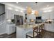 Spacious kitchen with stainless steel refrigerator, kitchen island with barstool seating and modern light fixtures at 132 Kobus Ct, Garner, NC 27529