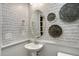 This stylish powder room features modern wallpaper, decorative wall plates and a brushed nickel faucet at 132 Kobus Ct, Garner, NC 27529