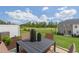 Backyard patio with an outdoor table, seating, and community landscaping at 136 Kobus Ct, Garner, NC 27529