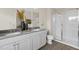 Modern bathroom featuring double sinks, white cabinetry, and a glass-enclosed shower at 136 Kobus Ct, Garner, NC 27529