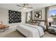Stylish bedroom featuring an upholstered bed, modern art, and a comfortable seating area at 136 Kobus Ct, Garner, NC 27529