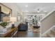 Open concept living room with modern decor flowing into kitchen and dining area at 136 Kobus Ct, Garner, NC 27529