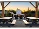 View of the fireplace in the community common area under a pergola, near picnic tables and seating at 140 Kobus Ct, Garner, NC 27529