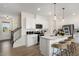 Bright, modern kitchen featuring white cabinets, a center island with seating, and stainless-steel appliances at 140 Kobus Ct, Garner, NC 27529