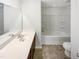 A simple bathroom with a single vanity, a large mirror, and a tub-shower combination at 1424 Elk Falls Dr, Wendell, NC 27591