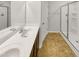 Bright bathroom featuring double vanity, white countertops, and a glass-enclosed shower at 1424 Elk Falls Dr, Wendell, NC 27591