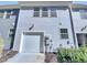 Exterior view of a two-story home with a one car garage and gray horizontal siding at 1424 Elk Falls Dr, Wendell, NC 27591