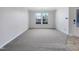 Spacious living area featuring neutral carpet and large windows for ample natural light at 1424 Elk Falls Dr, Wendell, NC 27591