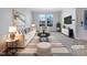 Bright, staged living room with striped accents, modern furniture, and natural light at 1424 Elk Falls Dr, Wendell, NC 27591